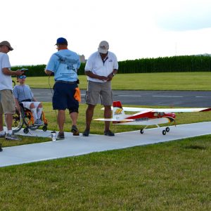 People working together to fly model planes