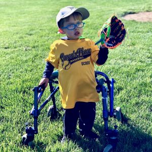 A child in the outfield ready to catch a baseball