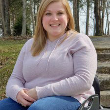 A young lady in a wheelchair with Spina Bifida