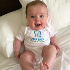 A Baby with the Spina Bifida Coalition logo on the outfit
