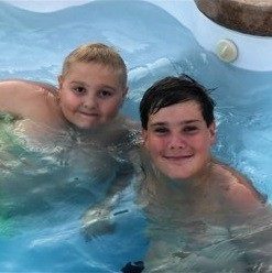 Scott and Landyn in a swimming pool