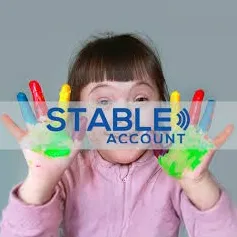 A child with paint on ther hands and the text STable Accout in front of them