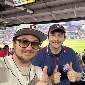 A board member mentoring a kid at a baseball game