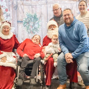 A family posing with Santa clause